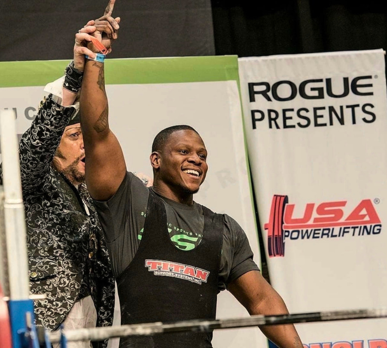 Powerlifter celebrating a winning lift on the competition platform